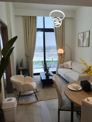 a living room with a couch and a table at Stylish 2B escape in Dubai
