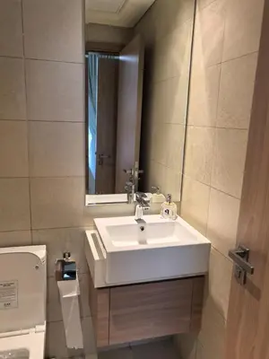 a bathroom with a sink and a mirror and a toilet at Stylish 2B escape in Dubai