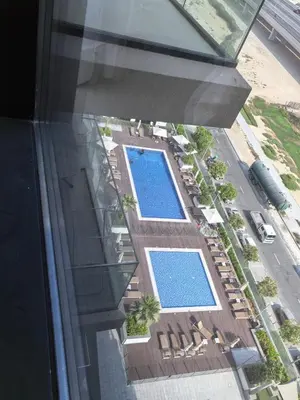 an overhead view of two swimming pools on a building at Stylish 2B escape in Dubai