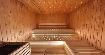 a sauna with a bench in a wooden room at Savis Homes - Stylish 1 BR near Metro Station in Business Bay in Dubai