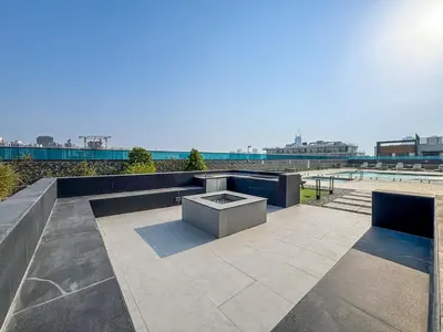 a patio with two benches and a table at Modern Studio with City Views Near Miracle Garden in Dubai