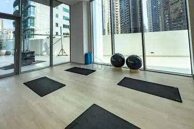 a yoga room with black mats on the floor at High-Floor Seaview 2BR with Dubai Water Canal Panorama, Steps from Metro and Marina Beach, LIV Marina, Dubai Marina by Deluxe Holiday Homes in Dubai