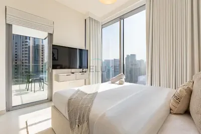 a bedroom with a large white bed and a large window at High-Floor Seaview 2BR with Dubai Water Canal Panorama, Steps from Metro and Marina Beach, LIV Marina, Dubai Marina by Deluxe Holiday Homes in Dubai