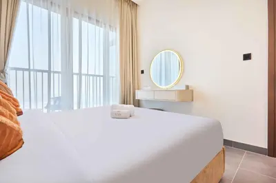 a white bedroom with a large bed and a mirror at STAY BY LATINEM Luxury 1BR Holiday Home CB 3113 Near Burj Khalifa in Dubai