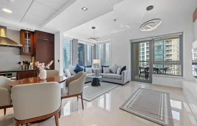 a kitchen and living room with a table and chairs at Luxury Apartment near Dubai Mall & Burj Khalifa at Emaar 29 Boulevard by Simply Comfort in Dubai
