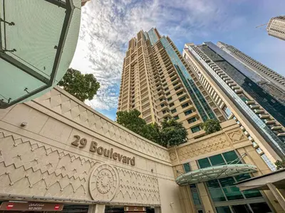 a building with two tall buildings in the background at Luxury Apartment near Dubai Mall & Burj Khalifa at Emaar 29 Boulevard by Simply Comfort in Dubai