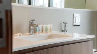 a bathroom with a sink with a faucet at Two Bedroom Apartment Down Town in Dubai