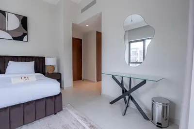 a bedroom with a bed and a glass table at Two Bedroom Apartment Down Town in Dubai