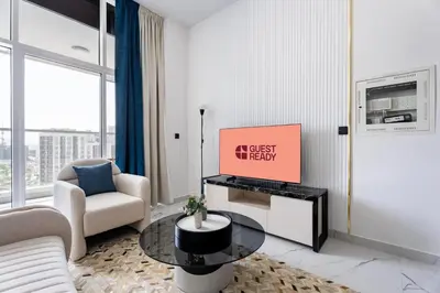 a living room with a couch and a table at GuestReady - 1 BHK | 5min to Butterfly Garden in Dubai