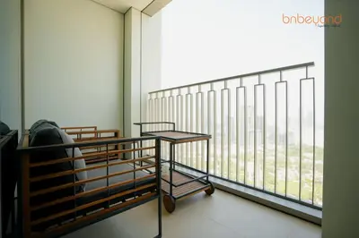 a room with a balcony with a large window at Bnbeyond Skyline Luxury in Dubai