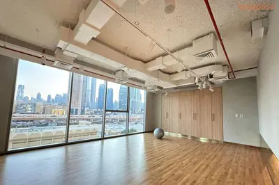 an empty room with a wooden floor and a large window at Bnbeyond Skyline Luxury in Dubai