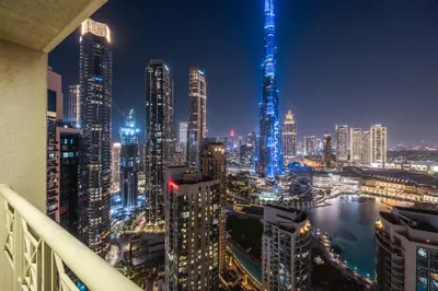 a view of a city skyline at night at Breathtaking Burj Khalifa & Fountain Views! in Dubai