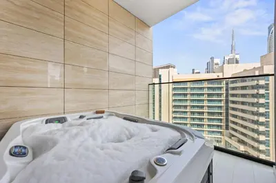 a bath tub with a view of a city at Trillionaire Residences By Binghatti - Classy 2BR in Dubai