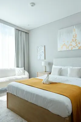 a bedroom with a large bed and a couch at Star of Dubai Marina 2 Br 5 Guests in Dubai