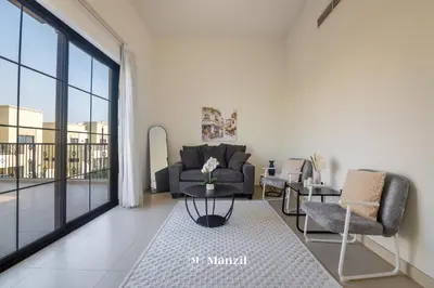 a living room with a couch and chairs and a large window at 4BR Villa in Prime Location with Private Garden in Dubai