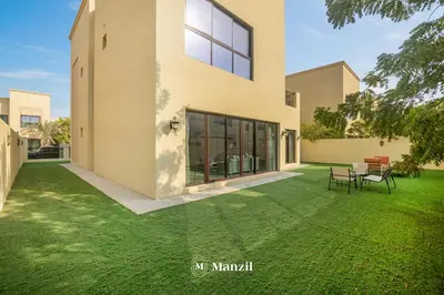 an exterior view of a house with a lawn at 4BR Villa in Prime Location with Private Garden in Dubai