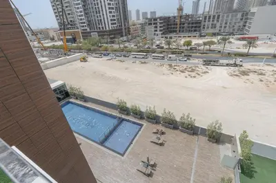 an overhead view of a beach and a swimming pool at Modern 1BHK Apartment in Pantheon JVC by Czechin in Dubai