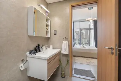 a bathroom with a sink and a bath tub at Modern 1BHK Apartment in Pantheon JVC by Czechin in Dubai