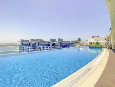 a swimming pool on top of a building at Wonderful Stay at 7 Palm - Rooftop Infinity Pool - Direct Beach Access - Brand New Luxury Apartments in Dubai