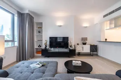 a living room with a couch and a tv at GlobalStay The Residences Tower 1 Apartments Downtown Dubai in Dubai