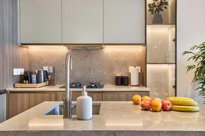 a kitchen with fruits and vegetables on a counter at Elegant Apartment near Miracle Garden with Pool & Gym Access in Dubai