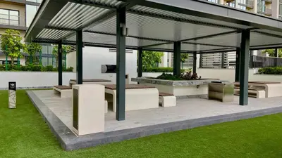 a pavilion with benches and tables in a building at Bright, Breezy and Central 1BR with Extra Room in Dubai