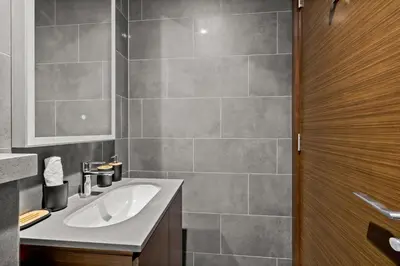 a bathroom with a sink and a mirror at Bright, Breezy and Central 1BR with Extra Room in Dubai