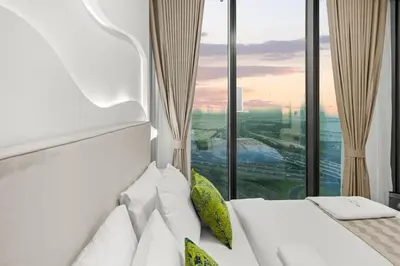 a hotel room with a bed and a large window at Bright, Breezy and Central 1BR with Extra Room in Dubai