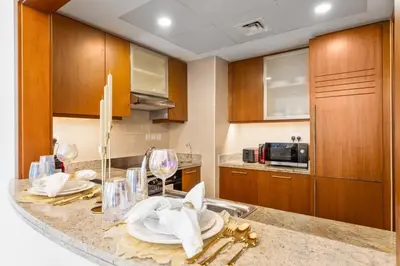 a kitchen with a counter top with a sink at Boema Apartments - Terrace with Stunning Burj View in Dubai