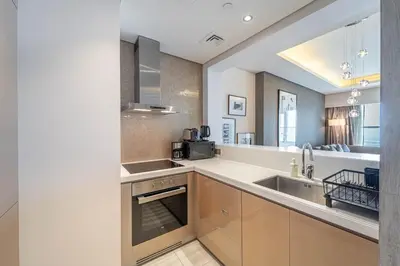 a kitchen with a sink and a counter top at Stylish Stay - 1 Bedroom - High Floor in Dubai