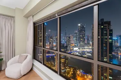 a room with a view of a city skyline from a window at GuestReady - 2BR | JBR Beach Stay | Canal View in Dubai