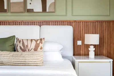 a bedroom with a white bed and a nightstand with a lamp at GuestReady - 2BR | JBR Beach Stay | Canal View in Dubai