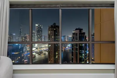 a view of a city skyline from a window at GuestReady - 2BR | JBR Beach Stay | Canal View in Dubai