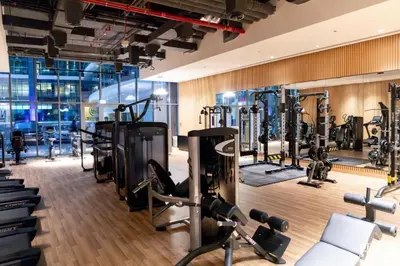 a gym with several treadmills and exercise machines at LUX Infinity Pool with GYM, Private Beach Studio in Dubai