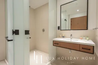 a bathroom with a sink and a mirror at LUX The Vida Marina Residence in Dubai