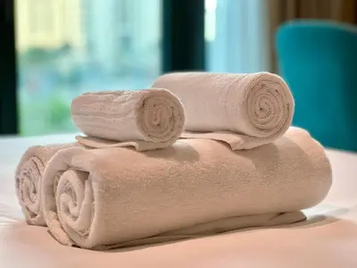a stack of towels sitting on top of a table at LUX Infinity Pool, Private Beach, GYM, Parking in Dubai