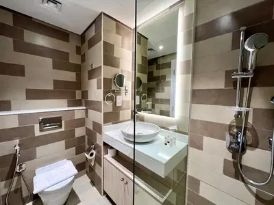 a bathroom with a toilet and a sink and a shower at LUX Infinity Pool, Private Beach, GYM, Parking in Dubai