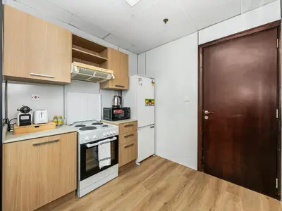 a kitchen with a stove and a refrigerator at Urban Dubai Marina Stay, Near Yacht Area & Beach Sleep 8 Pax in Dubai