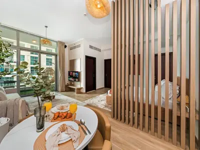 a living room with a table with a plate of food at Urban Dubai Marina Stay, Near Yacht Area & Beach Sleep 8 Pax in Dubai