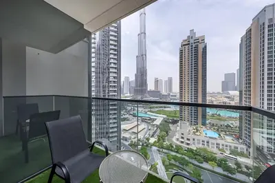 a balcony with chairs and a view of a city at Act One Luxury 2BR Front-Row Burj & Fountain Views in Dubai