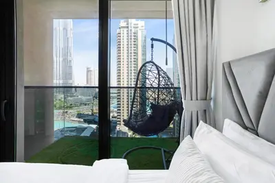 a bedroom with a hammock hanging from a window at Act One Luxury 2BR Front-Row Burj & Fountain Views in Dubai