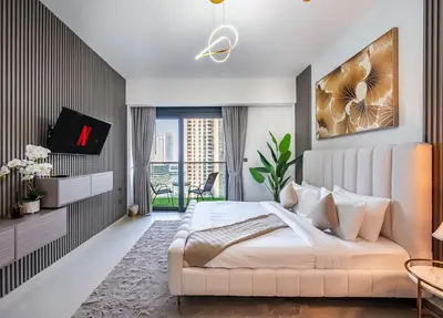a bedroom with a large bed and a tv at Act One Luxury 2BR Front-Row Burj & Fountain Views in Dubai