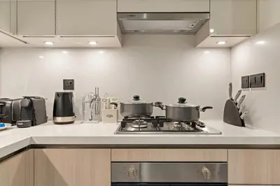 a kitchen with two pots on top of a stove at FIRST CLASS 2BR Bright and Elegant Living in Dubai