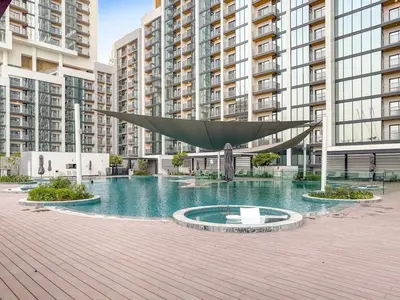 a large sculpture in front of some tall buildings at FIRST CLASS 2BR Bright and Elegant Living in Dubai