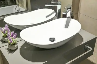a bathroom with two white sinks on a counter at Sylish Studio with Balcony Views Near Dubai Mall in Dubai