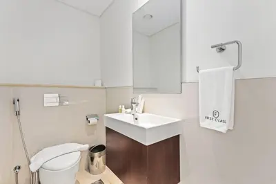 a white bathroom with a sink and a toilet at FIRST CLASS 2BR Luxury Living in Downtown in Dubai