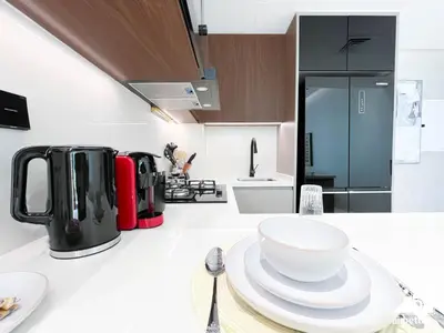 a kitchen with a white counter top with a bowl on a table at Luxury 1BR Escape, Resort-Style Living in Dubai in Dubai