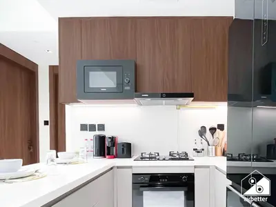 a kitchen with a tv on top of a stove at Luxury 1BR Escape, Resort-Style Living in Dubai in Dubai