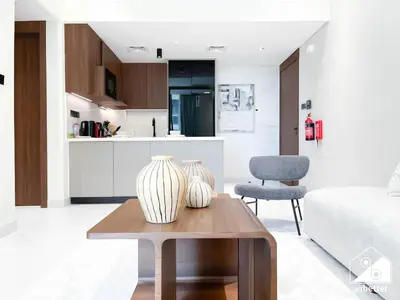 two vases sitting on a coffee table in a living room at Luxury 1BR Escape, Resort-Style Living in Dubai in Dubai