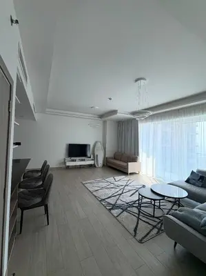 a living room with a couch and a table at Modern 1BR with city views large space in Dubai
